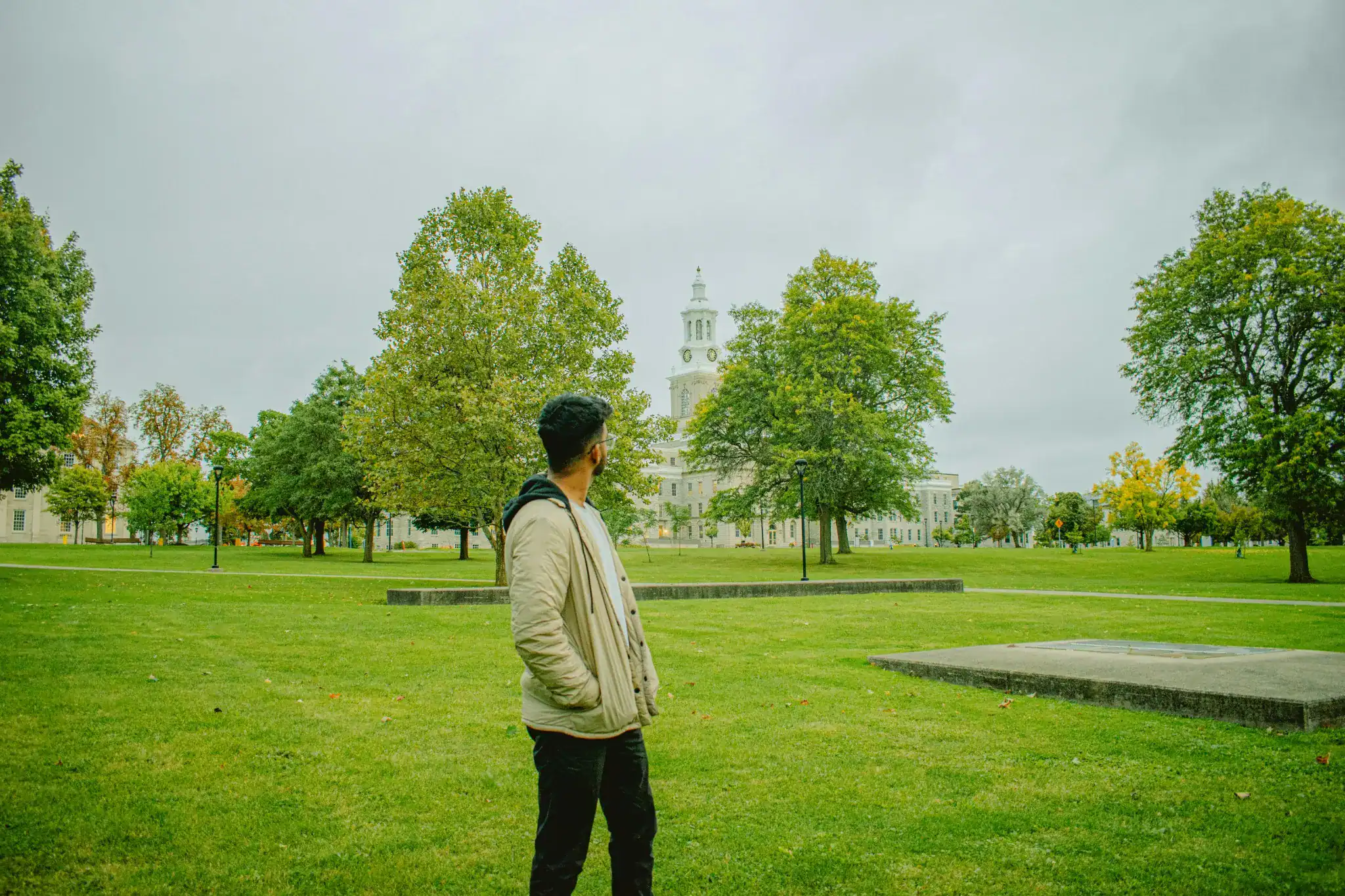 A remote worker walking mindfully in a peaceful green park during break time, symbolizing clarity and mental refreshment.